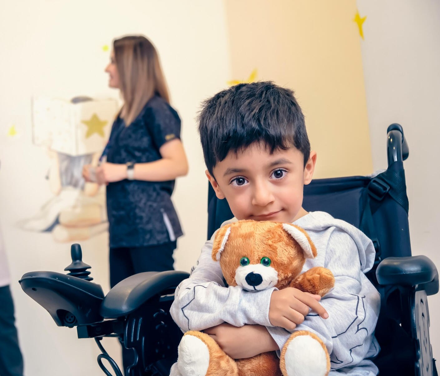 Child in wheelchair Photo of child in wheelchair holding teddy bear by Ortopediatri Cocuk Ortopedi Akademisi on Unsplash